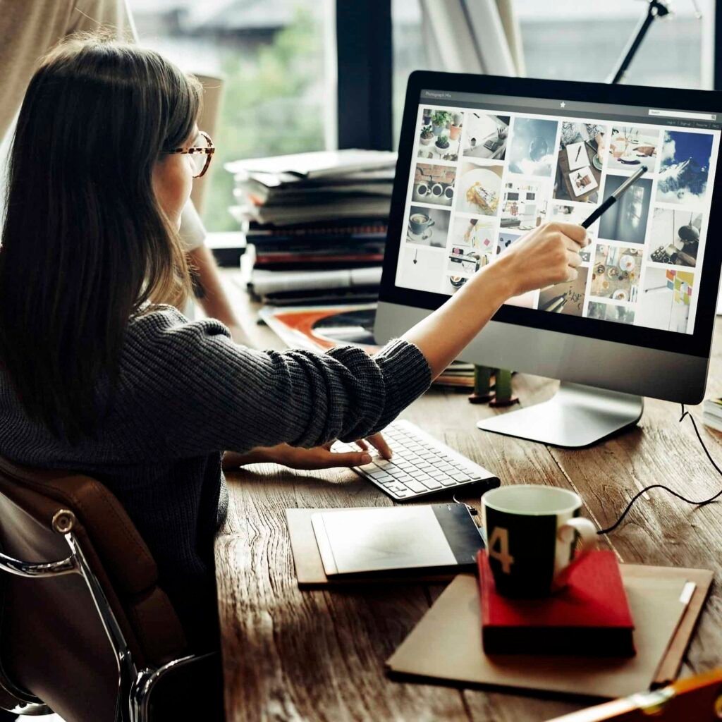 A female digital marketing agency expert sitting on the chair in front of desktop while working at Ranksis marketing agency in US